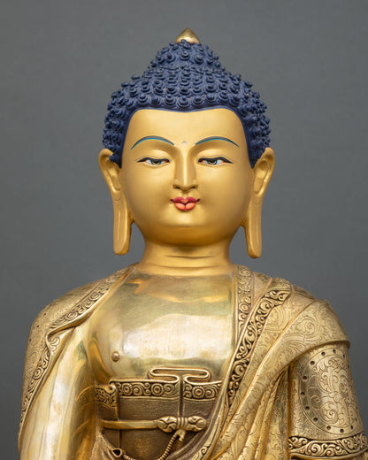 close-up of shakyamuni buddha statue with fire-gilded gold and detailed robe patterns