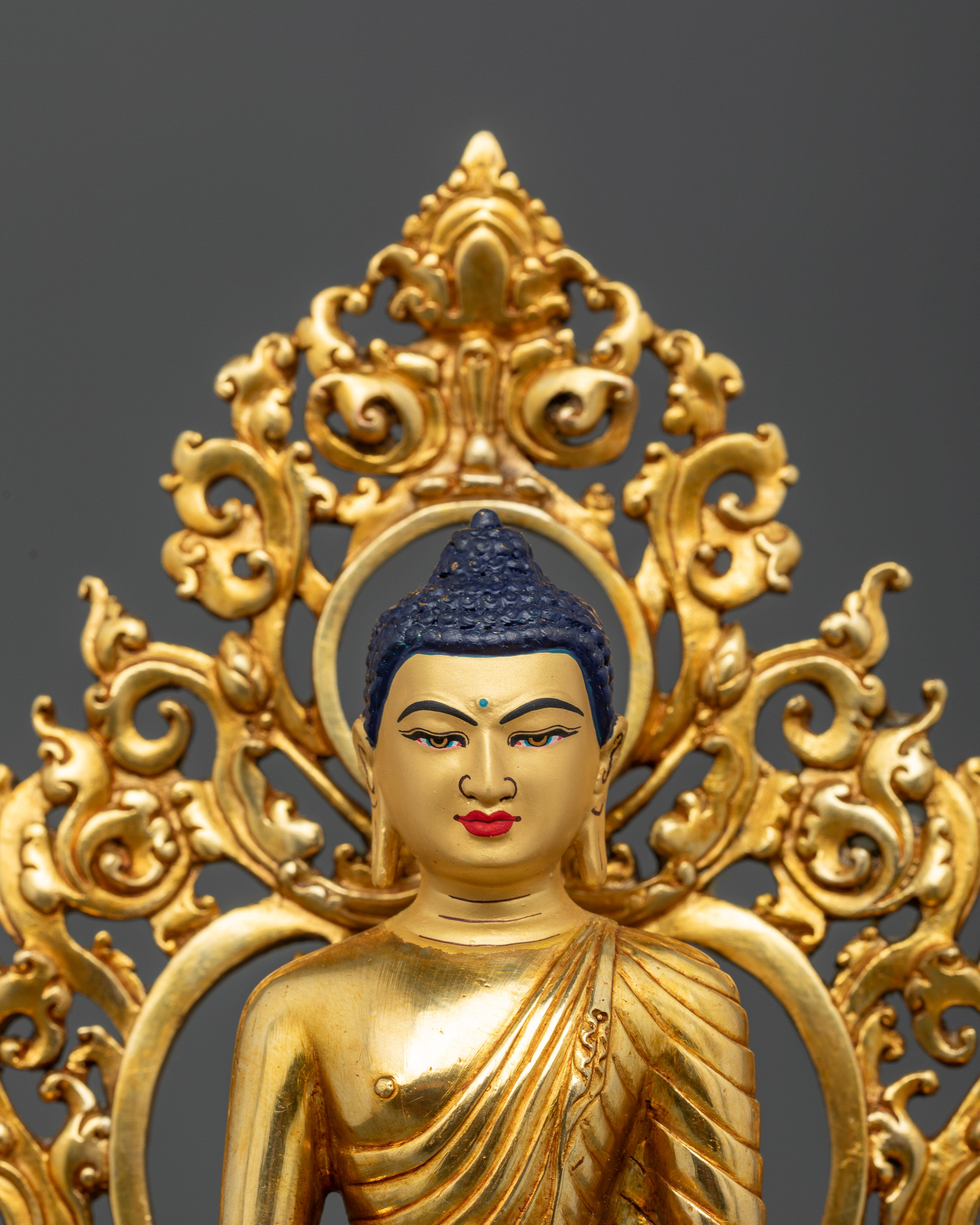 Close Up of Shakyamuni Buddha Statue with Gold Painted Face and Intricate Details