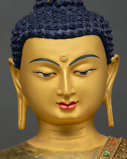 Close-up of Shakyamuni Buddha statue's serene golden face and urna mark
