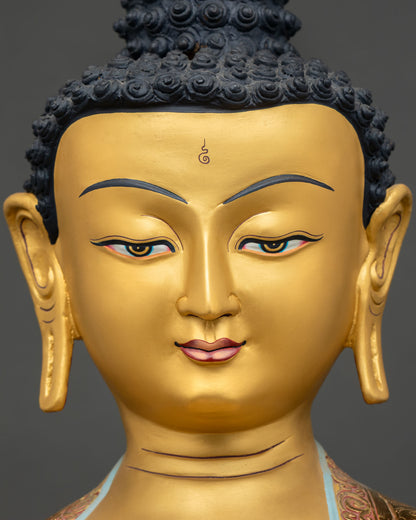 Close up of Shakyamuni Buddha with a calm gold painted face and peaceful expression