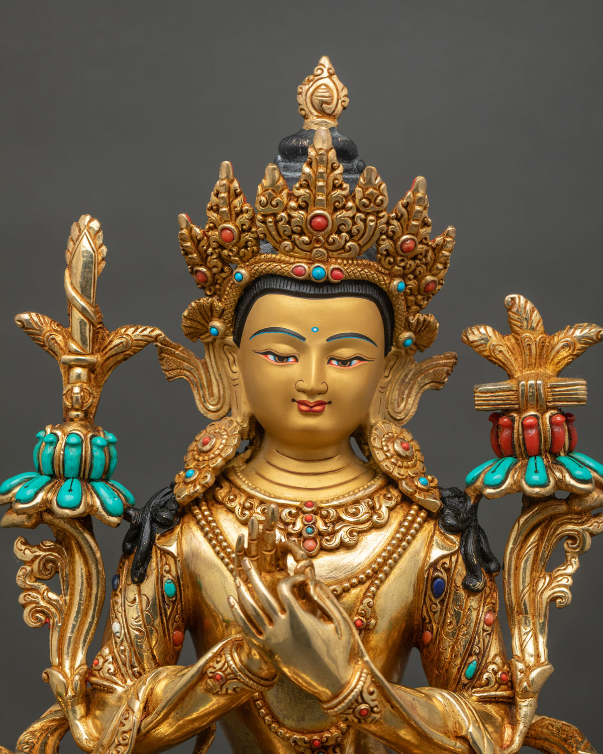 Close up of Simhanada Manjushri statue seated on a Snow Lion with gold fire-gilding from Nepal