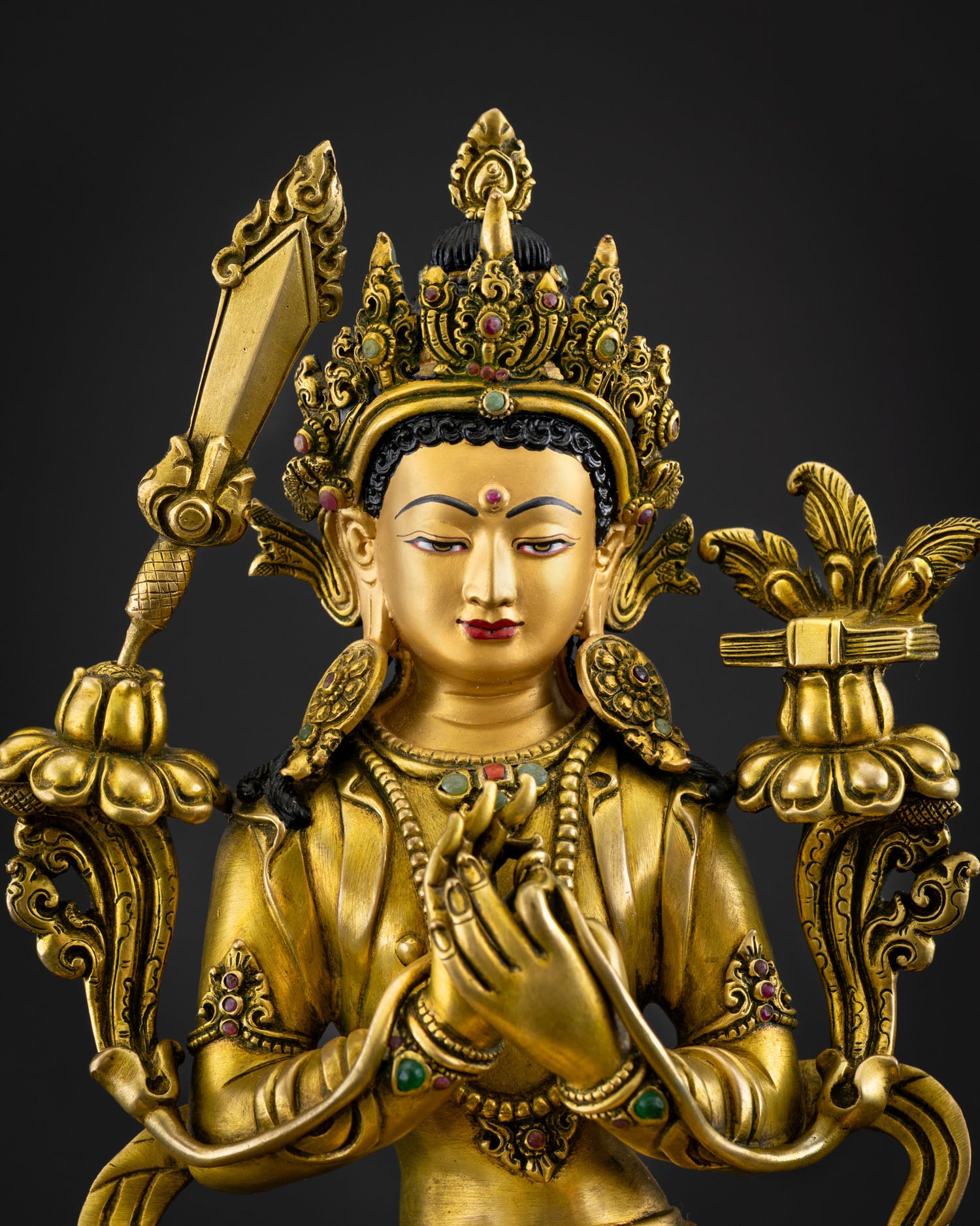 Close-up of Simhanada Manjushri statue with gold fire-gilded details