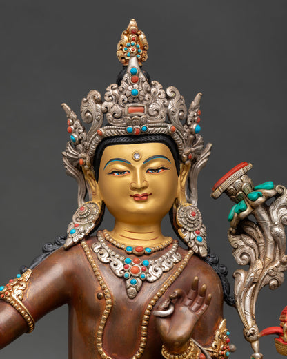close up of simhanada manjushri statue with gold gilded robe and lion throne