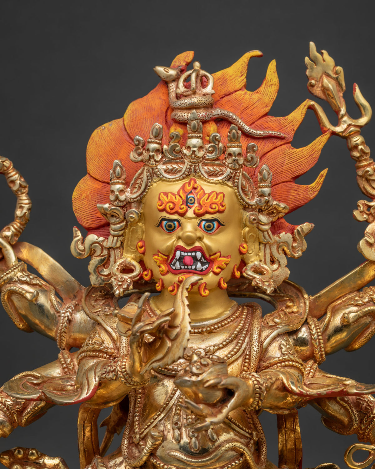 Close up of Six Arm Mahakala Statue with gold gilded copper body and ritual implements
