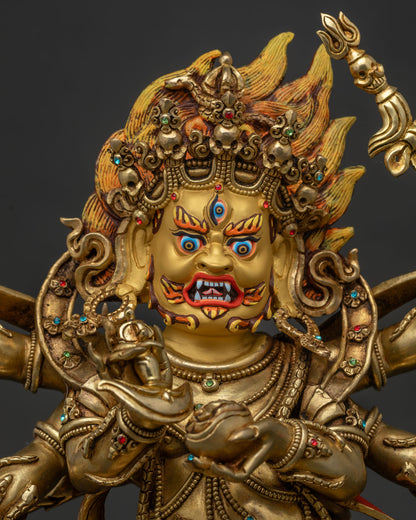 close up of six armed mahakala statue holding skull cup and trident
