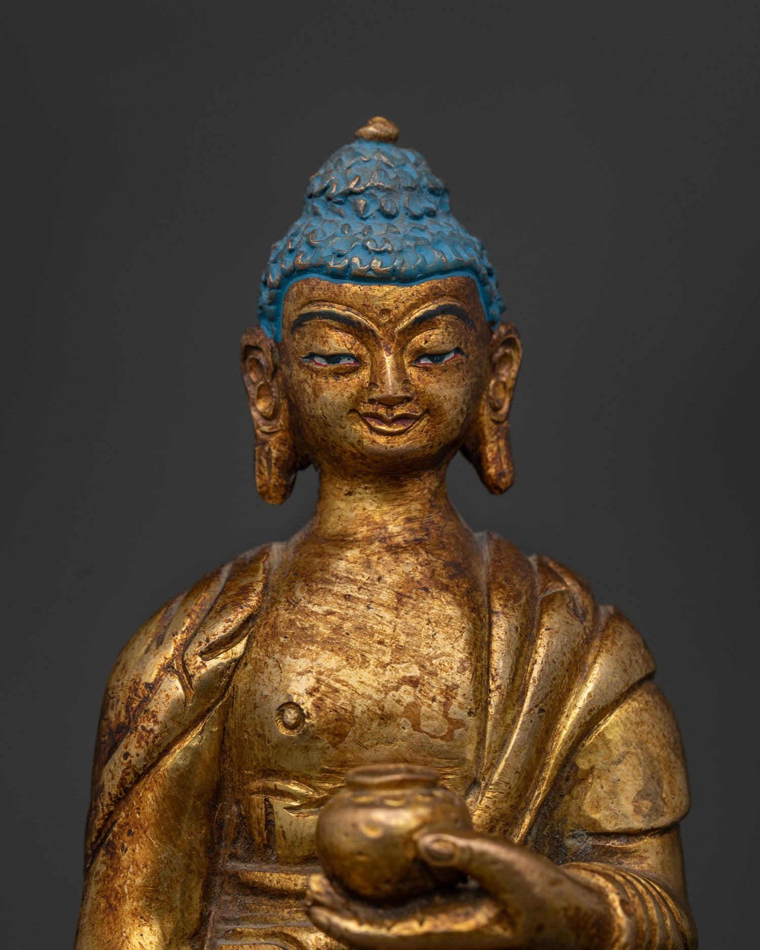 Close Up of Standing Shakyamuni Buddha Face with Hand Carved Monk Robe.