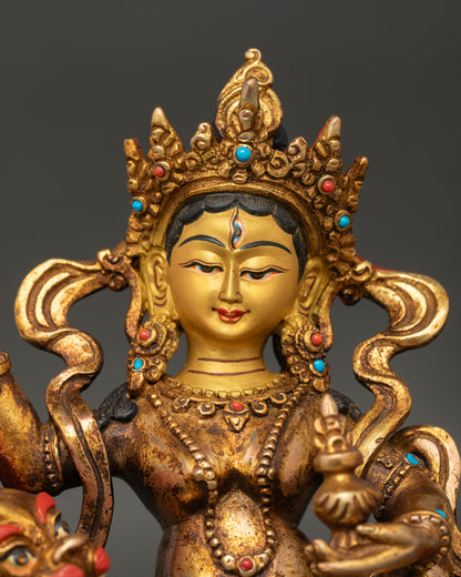 close-up of Tashi Tseringma goddess statue showing 24K gold-painted face details