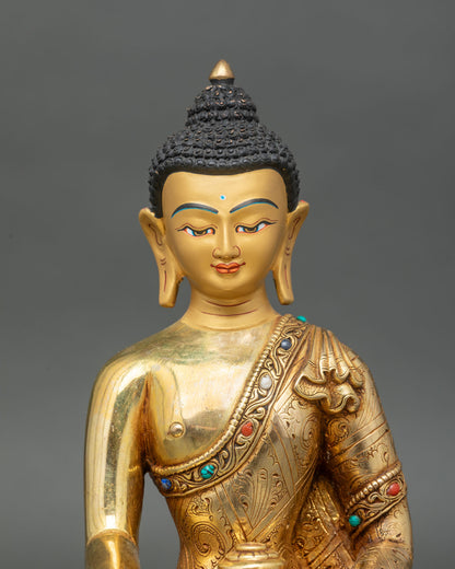 Close-up of the Shakyamuni Buddha’s serene gold-painted face with semi-precious stone inlays.