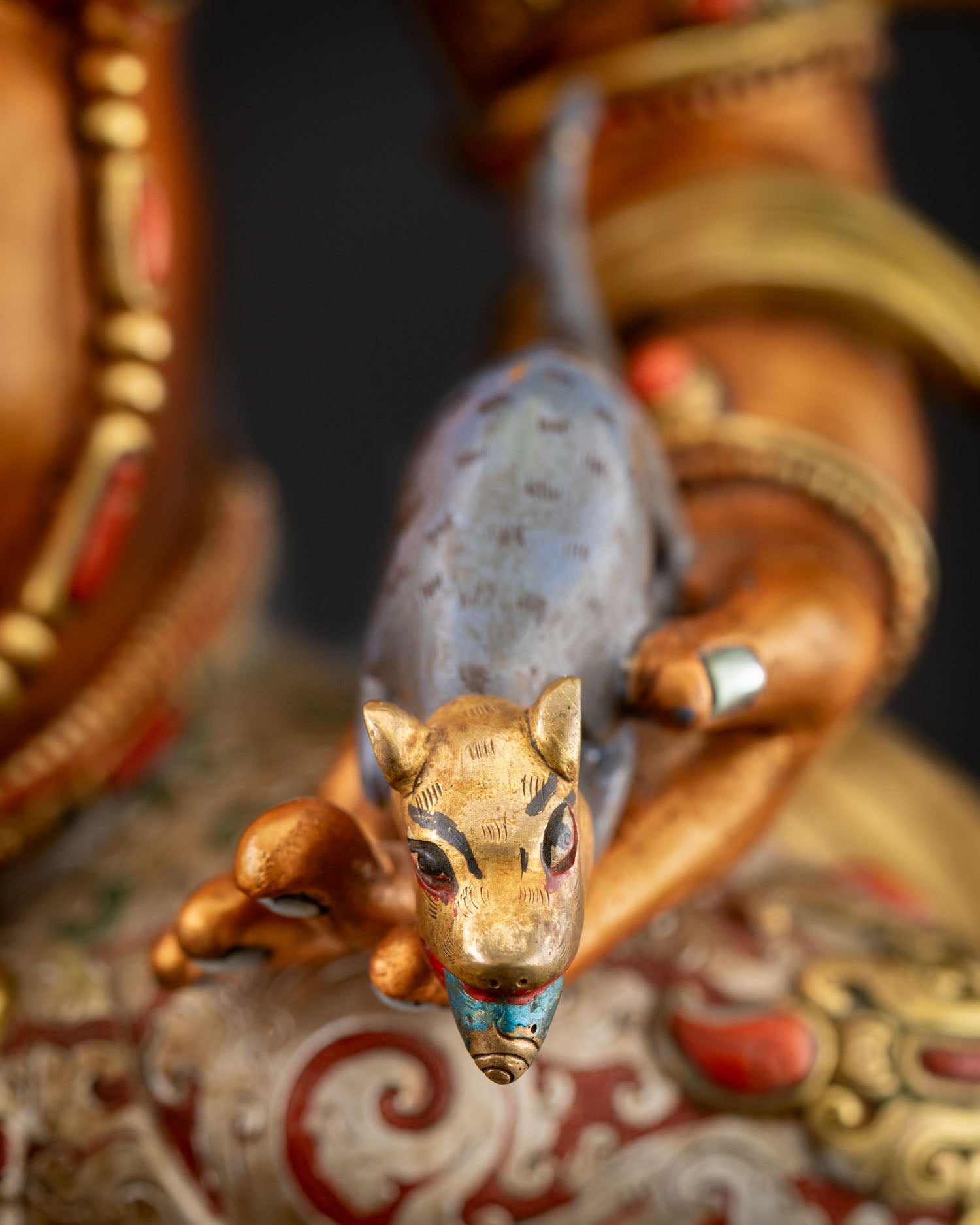 Close-up of the wealth-spouting (Nakula) mongoose held by Yellow Dzambhala