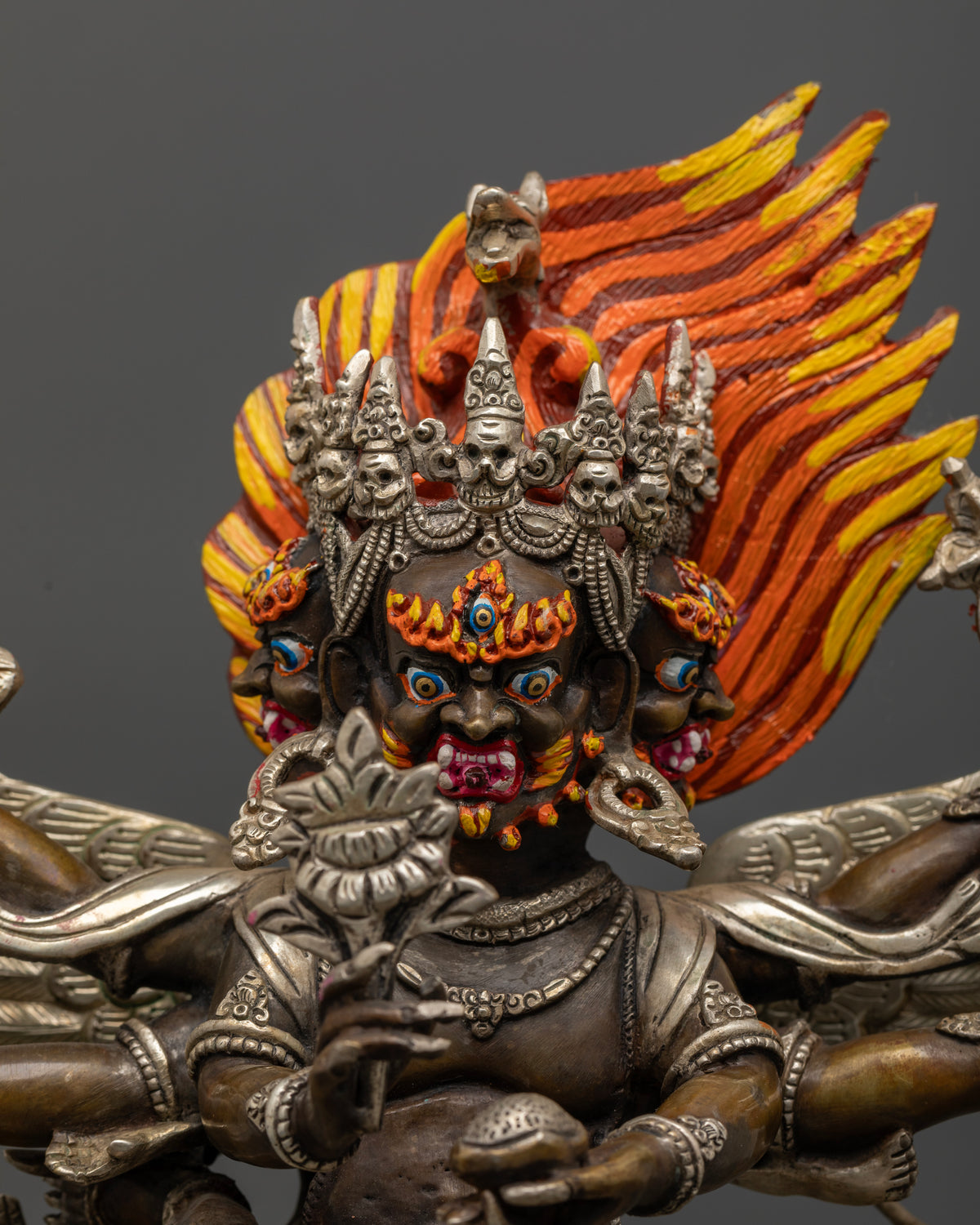 Close up of three faced Hayagriva with intricate silver plated details and wings