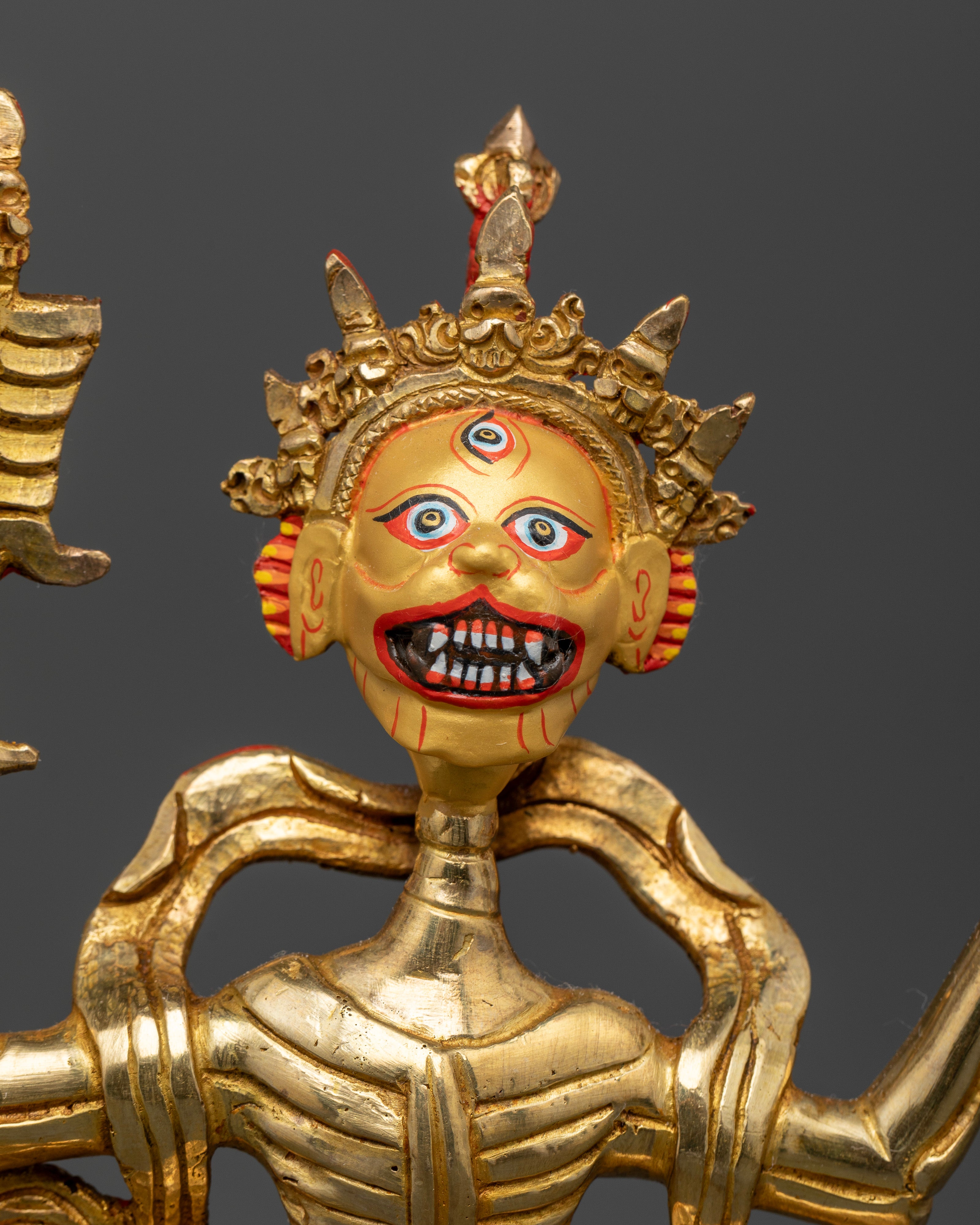 close up of Tibetan Buddhist Citipati statue with Five Dry Skull Crowns and flowing robes.