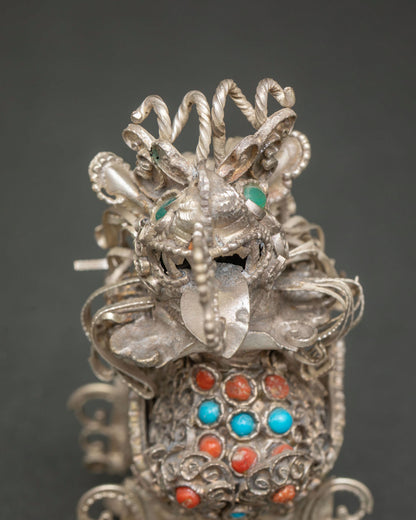 Close up of Tibetan Snow Lion statues showcasing detailed filigree and traditional Himalayan metalwork.