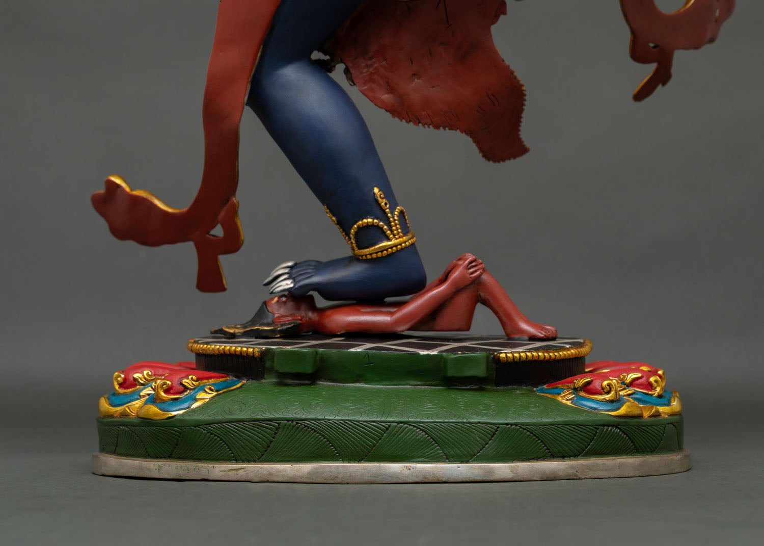 Close-up of Troma Nagmo Statue's feet on a hand-painted lotus base handcrafted in Nepal.
