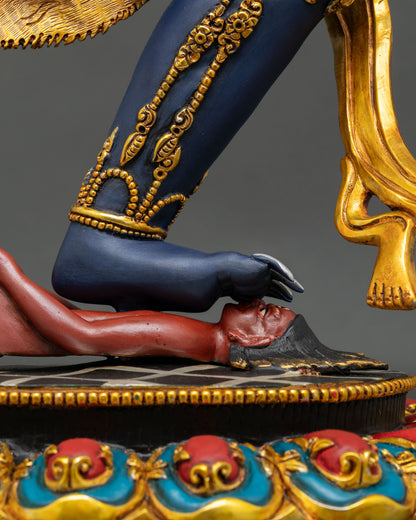 Close-up of Troma Nagmo Statue's foot subduing ignorance on a decorative lotus base.