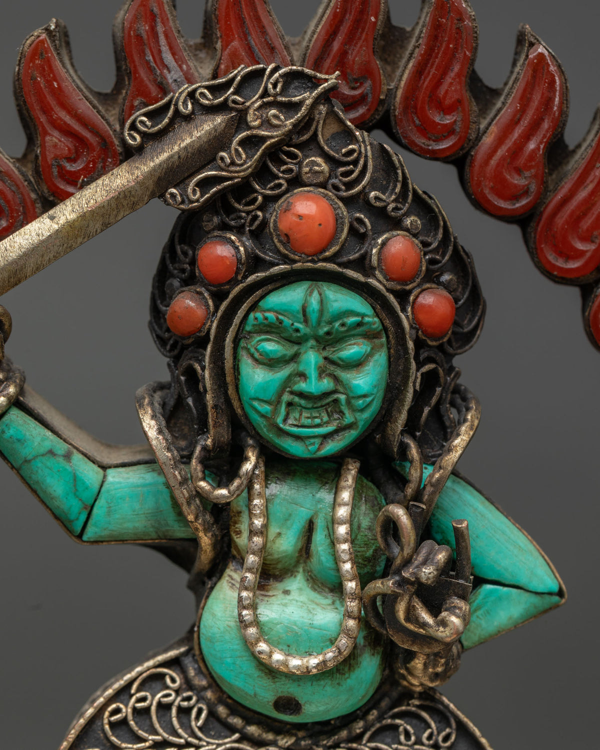 close up of turquoise sankata wrathful face and gemstone crown buddhist art from nepal