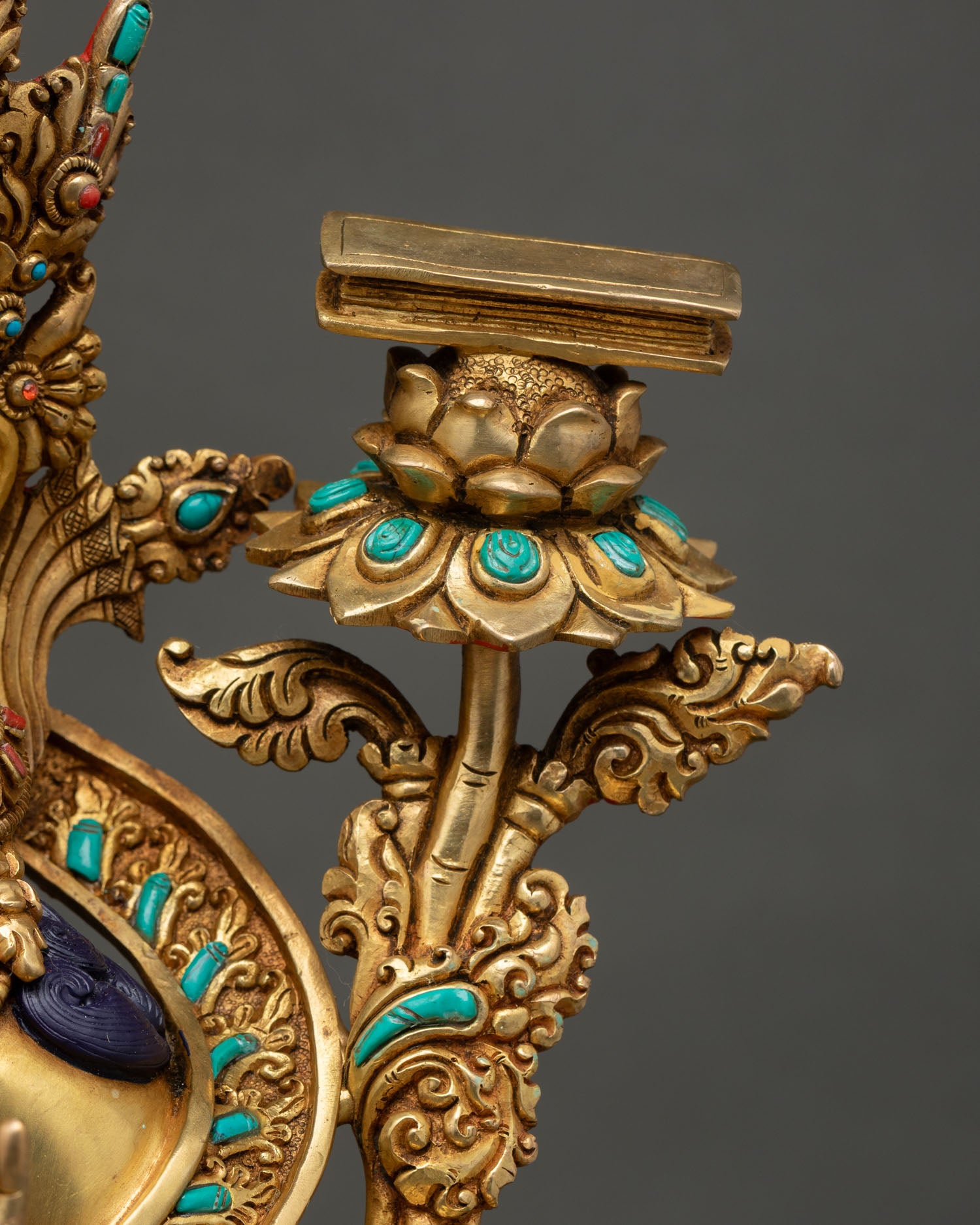 Close-up of utpala lotus supporting Prajnaparamita scripture beside Manjushri Statue