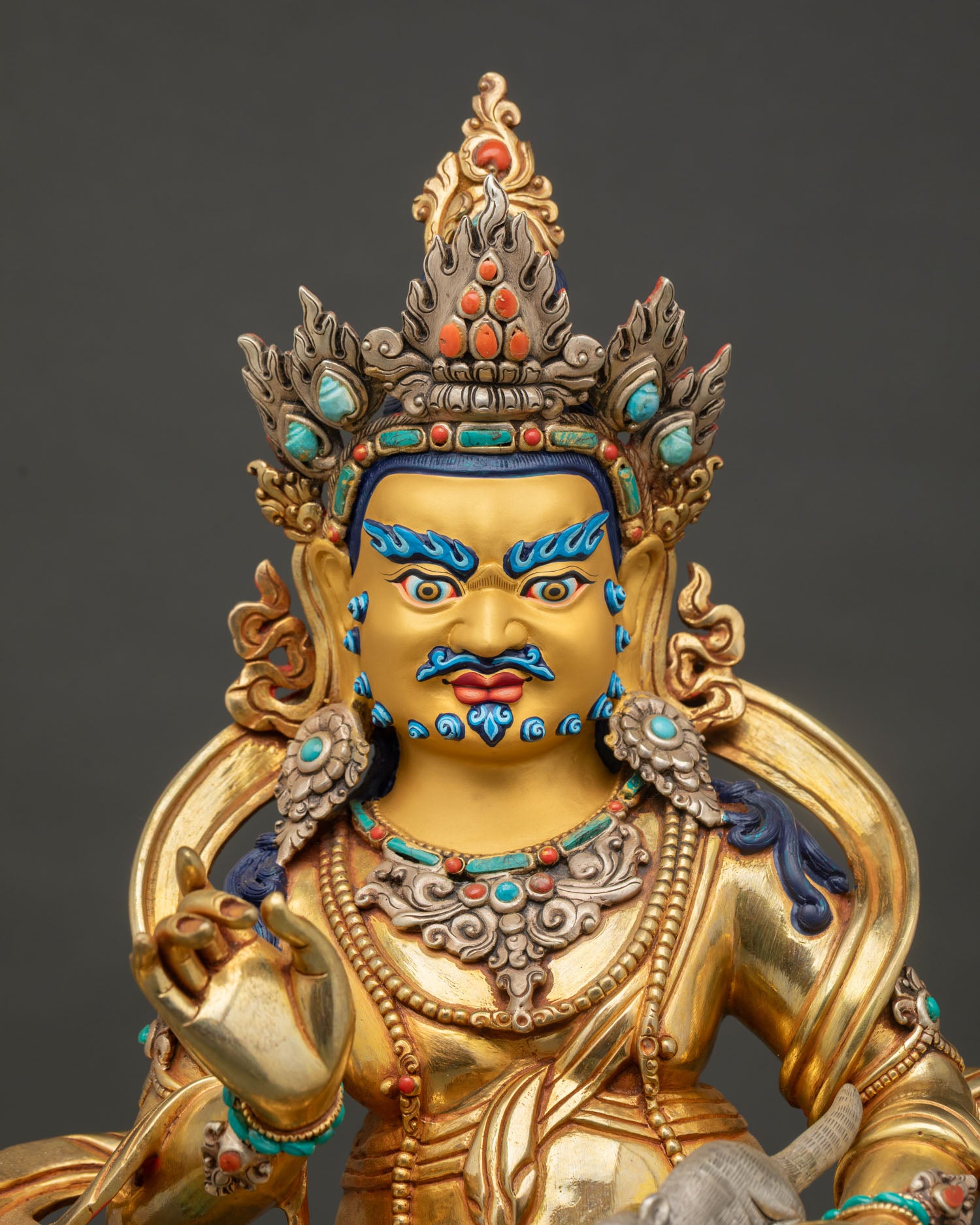 Close-up of Vaishravana Namtoshe Statue with jeweled crown and gold details