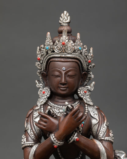 Close up of Vajradhara Buddha face showing serene expression silver plated detailing and Himalayan lost wax craftsmanship