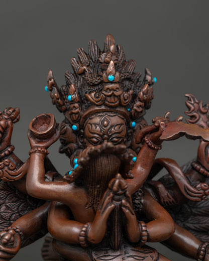 Close-up of Vajrakilaya statue’s ornate crown, turquoise stones and skull cup in hand