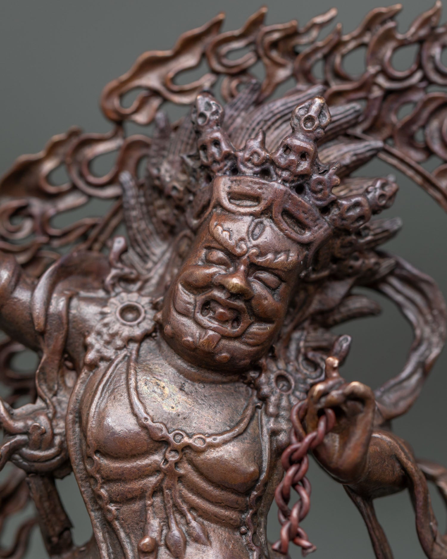 Close up of Vajrapani face with five skull crown and raised vajra handcrafted in Nepal.