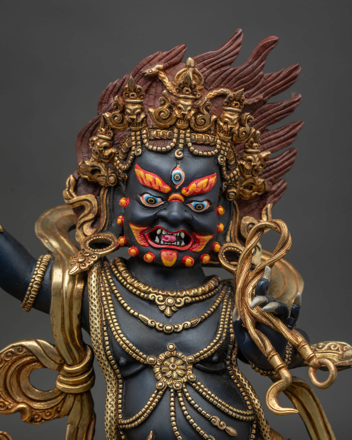 Close-up of Vajrapani Statue showing gold-gilded details and wrathful expression