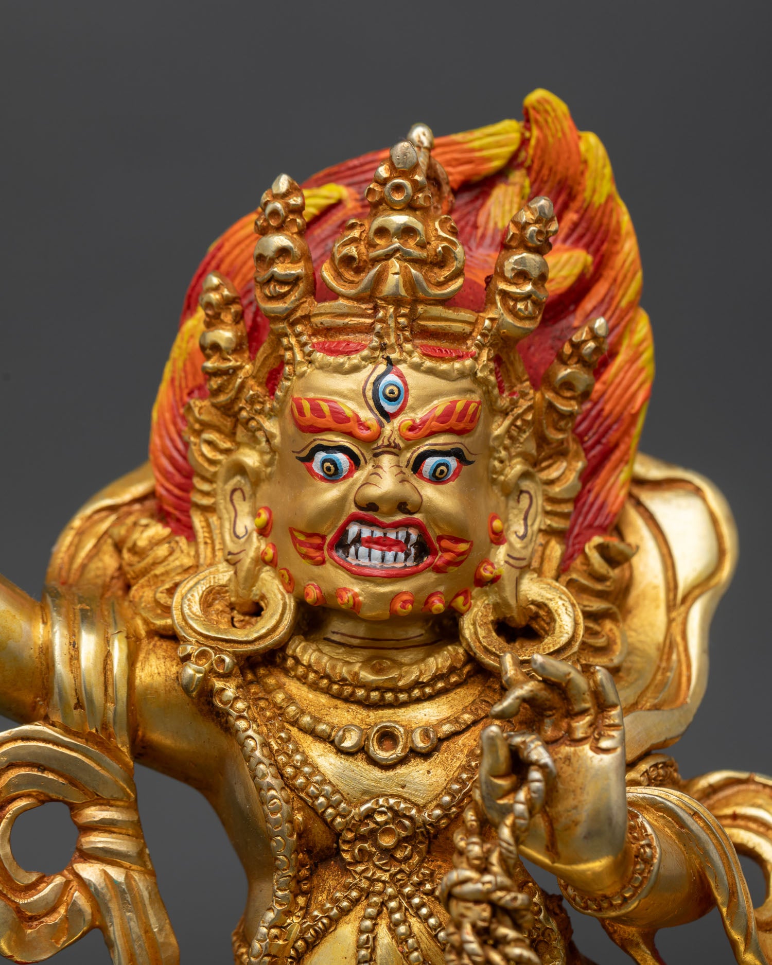 close-up of vajrapani statue showing intricate ornaments and gold gilded craftsmanship