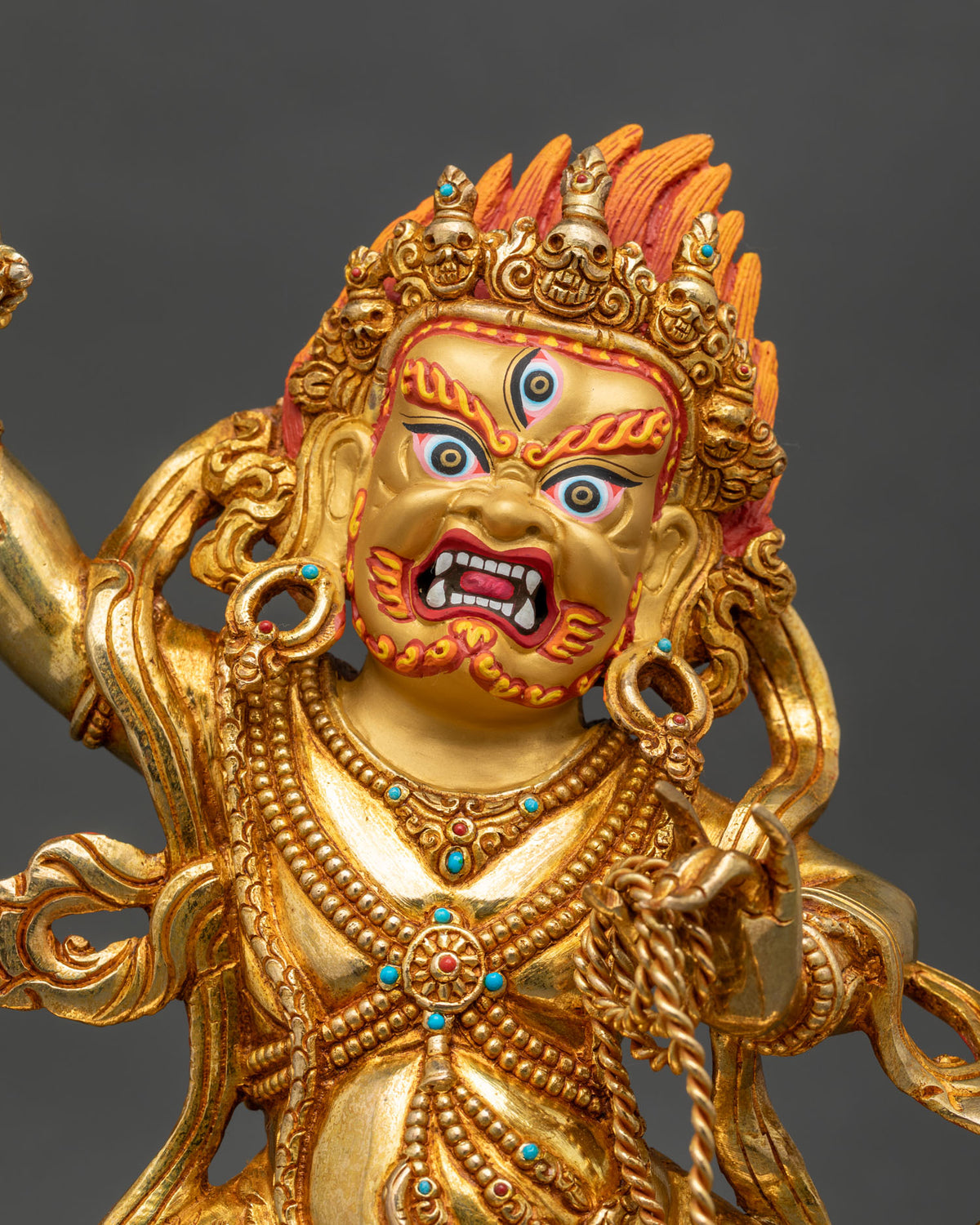 Close up of Vajrapani statue with vajra and lasso, gold-gilded copper altar statue from Nepal