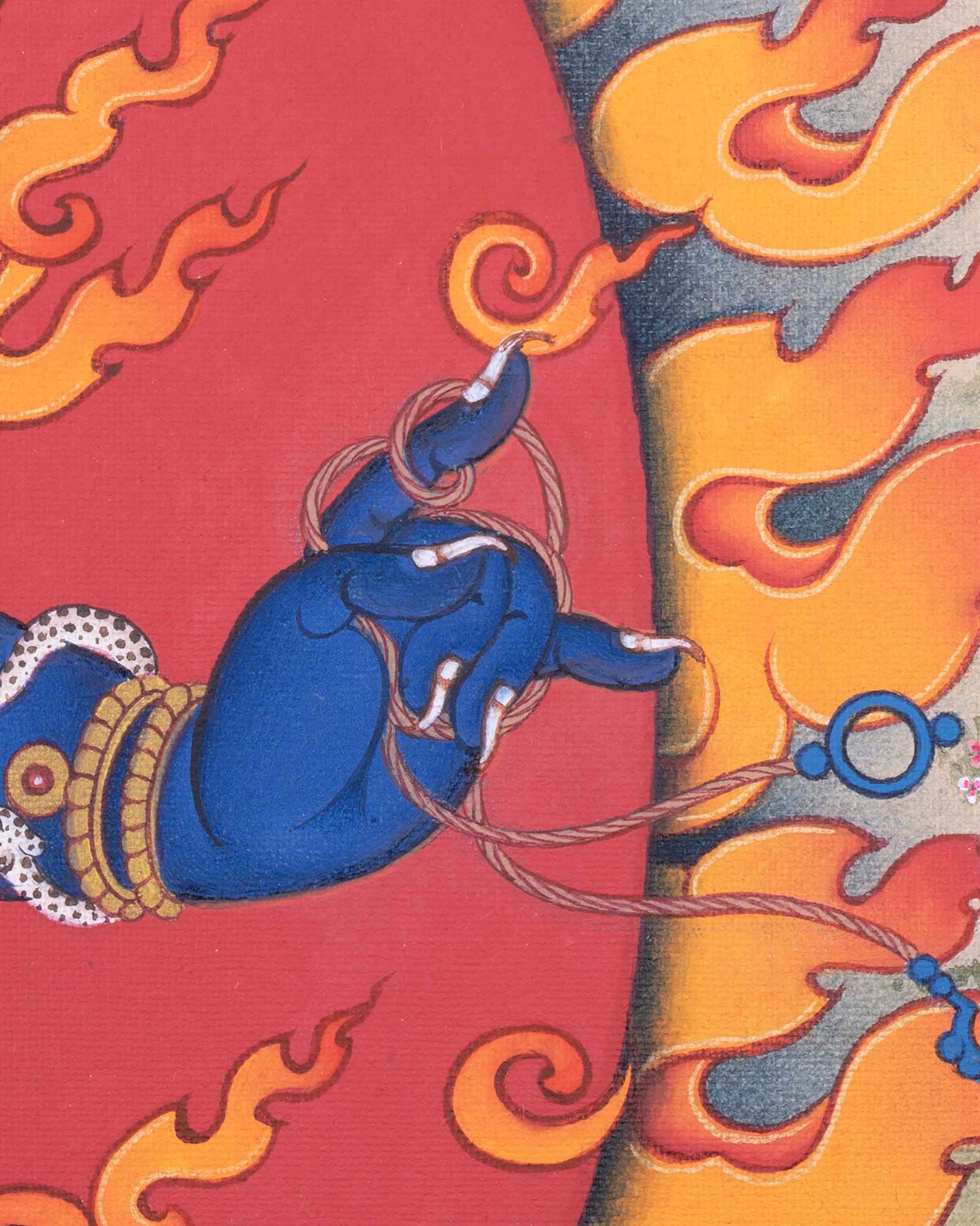 Close-up of Vajrapani's hand holding the lasso against fiery flame halo