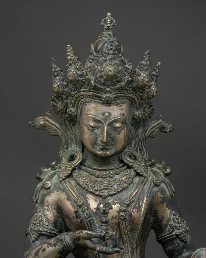 Close-up of Vajrasattva bronze statue showing crown, vajra, and bell detail