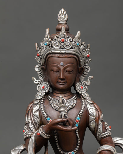 Close up of Vajrasattva Buddha face showing serene expression intricate detailing and Himalayan craftsmanship