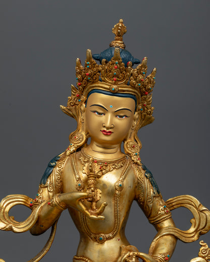 Close Up of Vajrasattva Buddhist Statue with Gold Painted Face and Vajra Bell Details