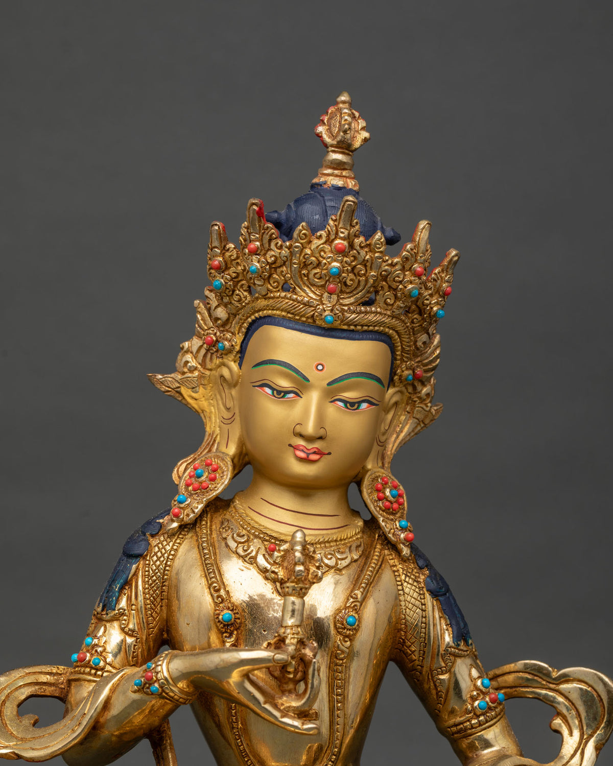 Close-up of Vajrasattva face and crown with gold pigment details and blue accents