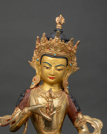 Close-up of Vajrasattva face and vajra with calm gilded expression and Five-Jewel Crown
