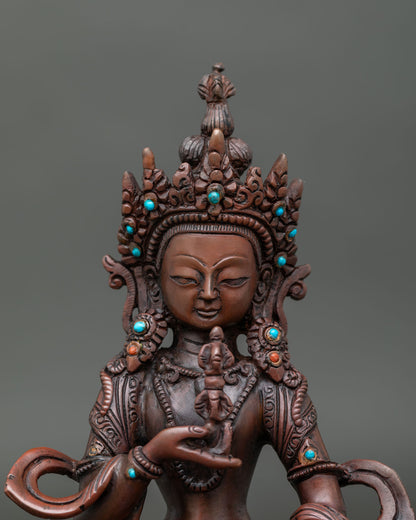 Close up of Vajrasattva statue serene face jeweled crown and finely chased Newari jewelry.