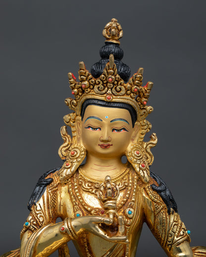 Close up of Vajrasattva statue showing gold painted face and intricate Newari craftsmanship.