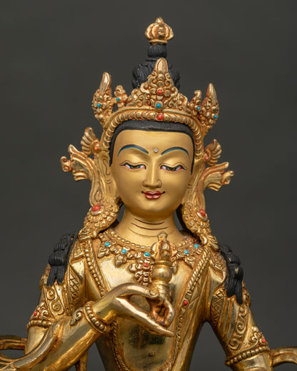 Close up of Vajrasattva statue with gold painted face and semi precious stone details