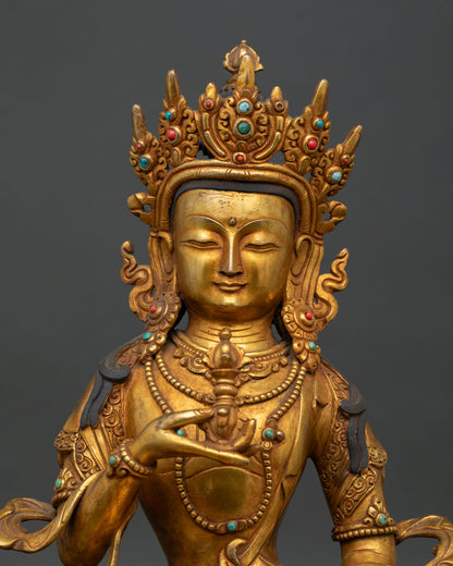 Close-up of Vajrasattva Statue with peaceful face ornate crown and antique copper finish.
