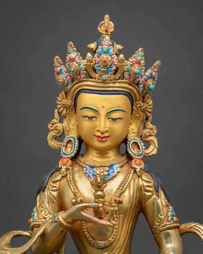 Close up of Vajrasattva statue with vajra and bell, fire-gilded copper Tibetan Buddhist art from Nepal