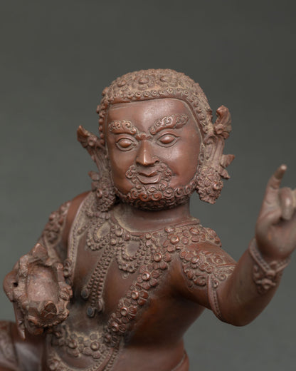 Close up of Virupa statue showing intricate jewelry lotus seat and skull cup symbolism