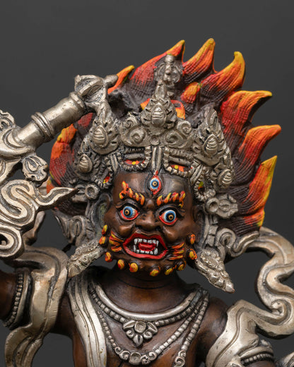 Close-up of White Dzambhala face with skull crown and silver-plated details in Himalayan art style