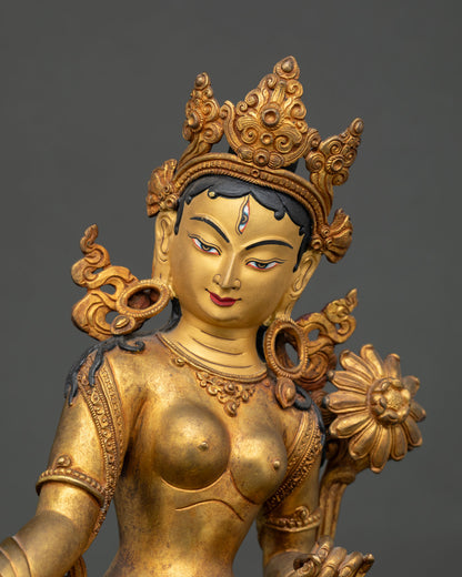 Close up of White Tara Bodhisattva gold painted face and intricate Himalayan artwork details