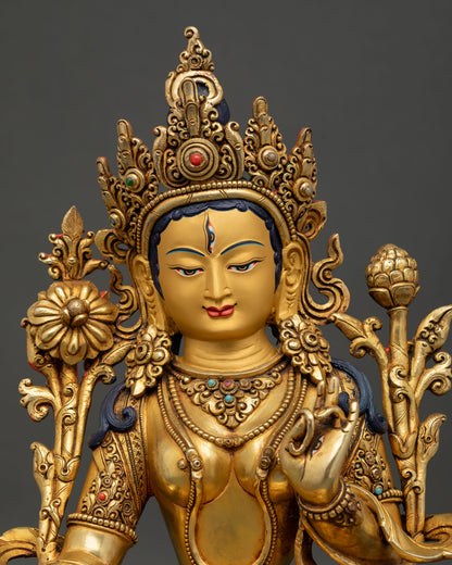 Close up of White Tara Buddhist statue showing gold painted face and seven all seeing eyes