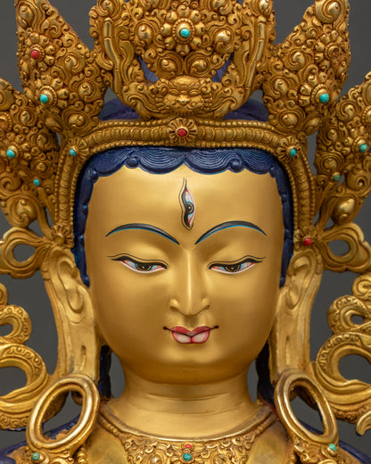 Close-up of White Tara statue's gold-painted face with seven compassionate eyes