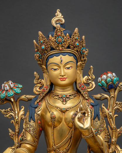 Close-up of White Tara statue, gold-gilded copper sculpture with lotus flowers
