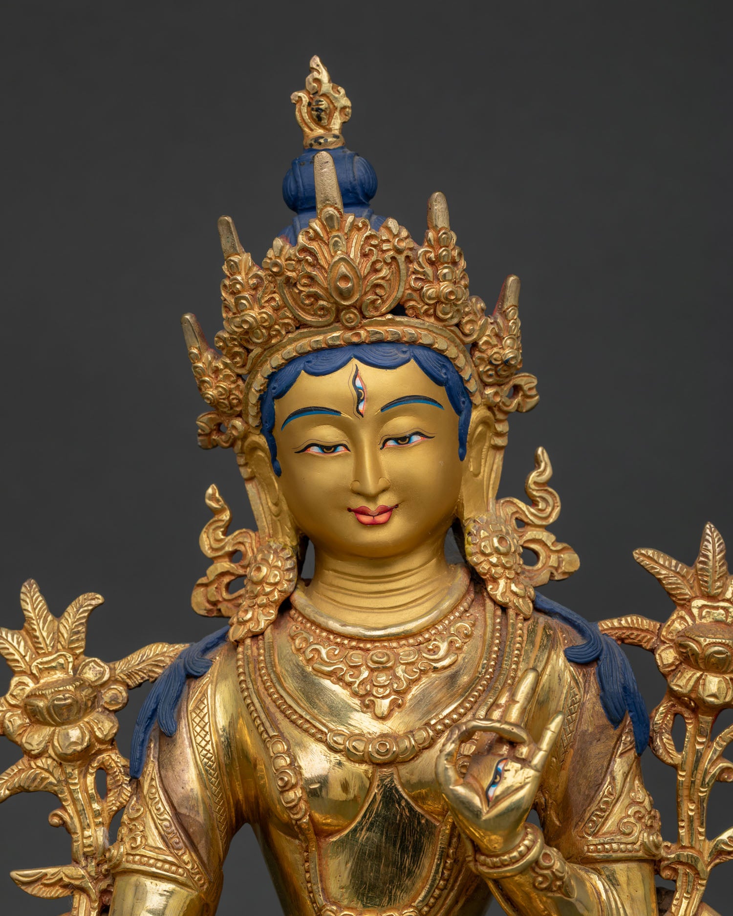 Close Up of White Tara Statue Gold Painted Face with Serene Expression