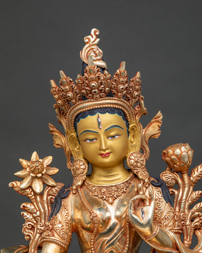 Close up of White Tara statue showing serene 24K gold painted face jeweled crown and detailed Buddhist craftsmanship.