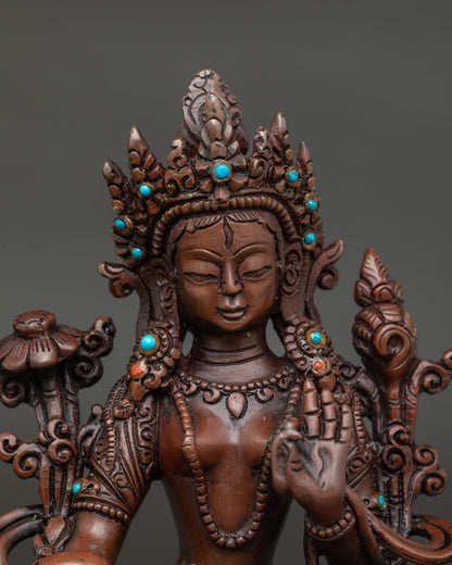 Close up of white tara statue showing seven all seeing eyes and serene expression.