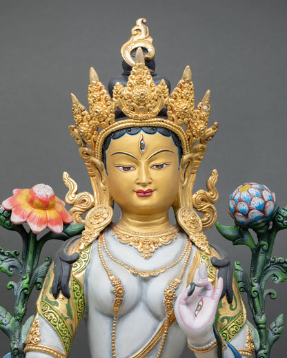 close-up of white tara statue with acrylic colors and gold-gilded details