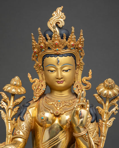 close-up of white tara statue with gold fire gilding and intricate lotus detailing