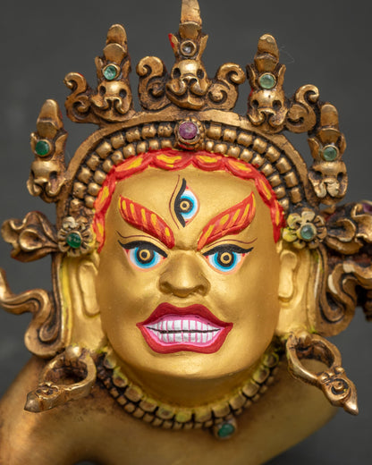 Close-up of wrathful Hevajra face with third eye, flaming eyebrows and jeweled skull crown